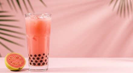 Refreshing guava bubble tea on pink background with palm shadows