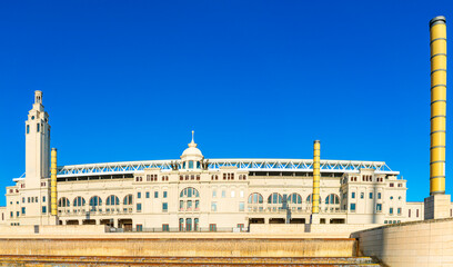 Obraz premium Olympic stadium in Barcelona with tall yellow columns and a grand facade