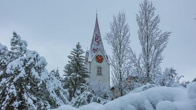 Time lapse, European town covered with snow. View towards Reformed Church. Hoengg district in town Zurich, Switzerland.
