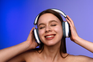 Young Woman Enjoying Music Through Headphones with Closed Eyes