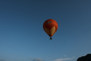 A hot air balloon is flying in the sky