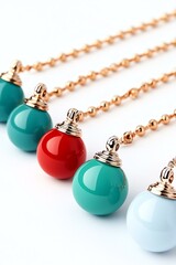 A vibrant collection of colorful pendants on delicate chains, showcasing a playful blend of red, teal, and white, perfect for stylish accessorizing.