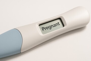 Digital pregnancy test showing positive result isolated on white