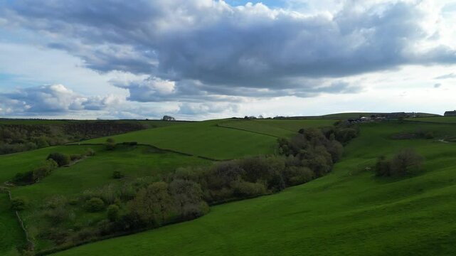 High Angle View of British Agricultural Farms at Countryside and Beautiful Landscape of Near Hills of Rotherham, England Great Britain of UK. April 30th, 2024.  Drone's Camera Footage