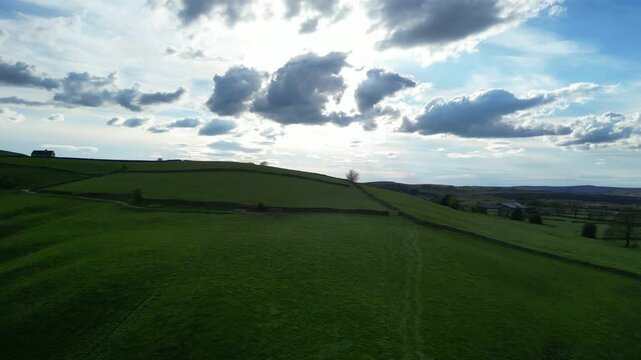 High Angle View of British Agricultural Farms at Countryside and Beautiful Landscape of Near Hills of Rotherham, England Great Britain of UK. April 30th, 2024.  Drone's Camera Footage