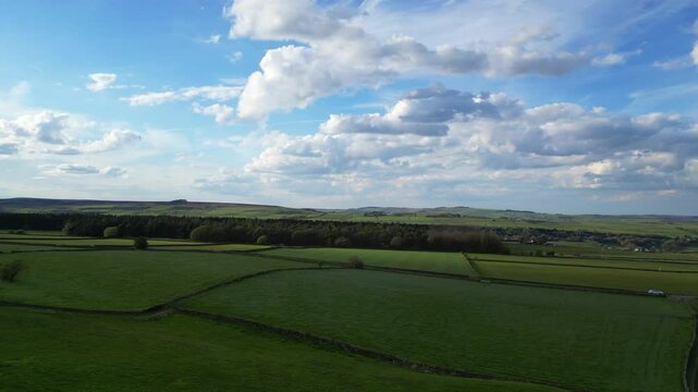 High Angle View of British Agricultural Farms at Countryside and Beautiful Landscape of Near Hills of Rotherham, England Great Britain of UK. April 30th, 2024.  Drone's Camera Footage