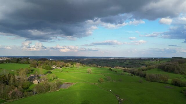 High Angle View of British Agricultural Farms at Countryside and Beautiful Landscape of Near Hills of Rotherham, England Great Britain of UK. April 30th, 2024.  Drone's Camera Footage
