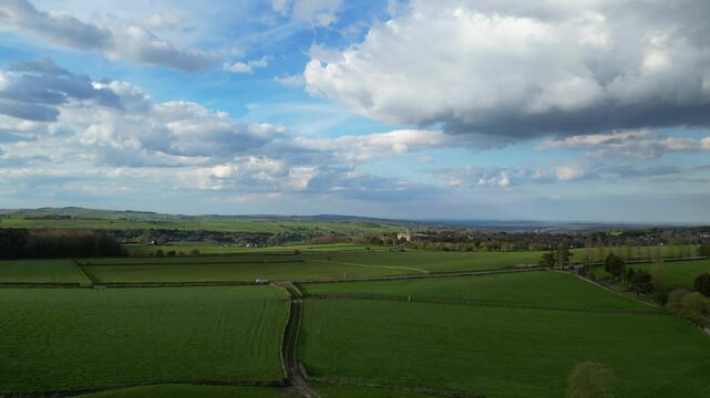 High Angle View of British Agricultural Farms at Countryside and Beautiful Landscape of Near Hills of Rotherham, England Great Britain of UK. April 30th, 2024.  Drone's Camera Footage