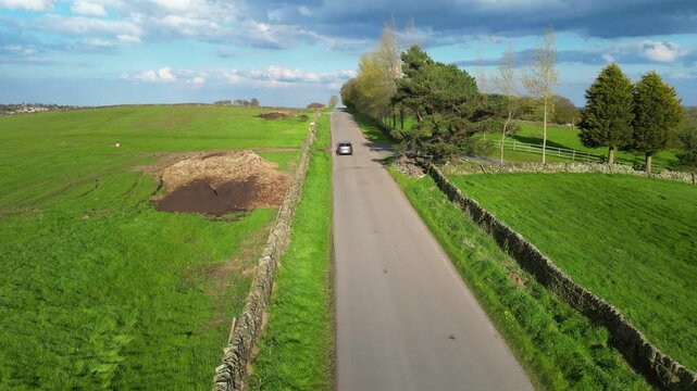 High Angle View of British Agricultural Farms at Countryside and Beautiful Landscape of Near Hills of Rotherham, England Great Britain of UK. April 30th, 2024.  Drone's Camera Footage