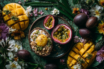 Obraz premium A vibrant display of tropical fruits with mango passion fruit and a coconut bowl surrounded by flowers