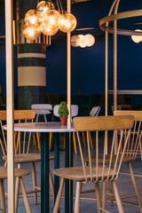 Modern Cafe Interior with Stylish Chairs and Ambient Lighting – Contemporary Club Design