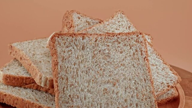 Whole wheat multigrain bread sliced on wooden table.