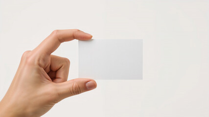 Obraz premium Woman hand holding empty business card on white background