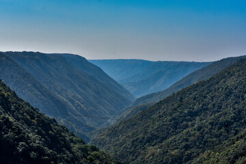 Expansive view of a deep, forested valley in the Khasi Mountains, Meghalaya.