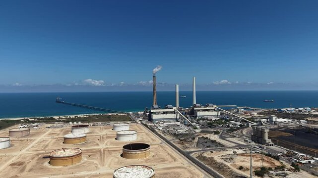 industrial smokestacks emitting plumes of smoke or steam into the atmosphere does climate change and energy	

