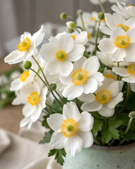 Fototapeta premium White anemone flowers with yellow centers, styled on the lower right