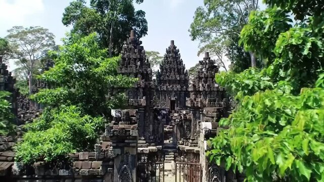 A serene view of the remains of Indonesia's magnificent temples and historical architecture, surrounded by nature.