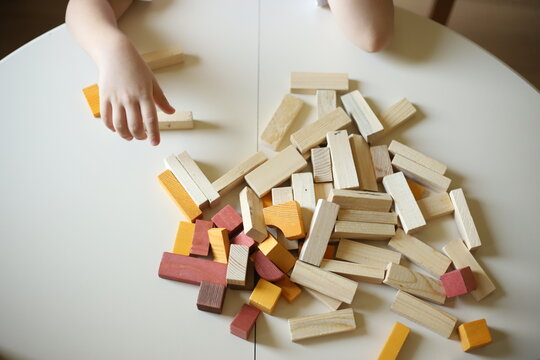 hand holding a wooden toys