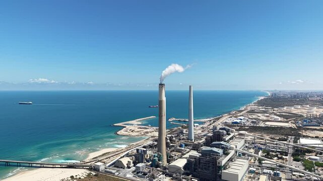 industrial smokestacks emitting plumes of smoke or steam into the atmosphere does climate change and energy	
