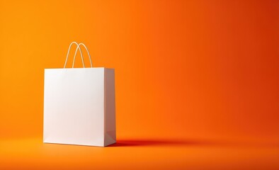 White paper shopping bag on bright orange background