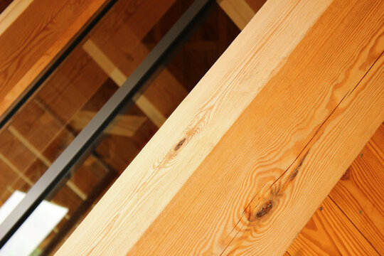 Scandinavian-Inspired Wooden Building with Black Window Frames and Heavy Timber Elements