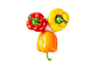 Fresh juicy shiny red, yellow and orange bell peppers. Isolated on white.