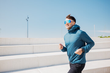 Bright Sunny Day Inspires Energetic Jogger on Outdoor Steps Showcasing Fitness and Determination in...