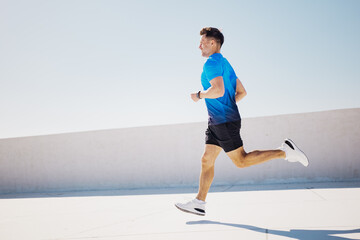 Running Against a Clear Blue Sky on a Bright Sunny Day, an Athlete Enjoys the Freedom of Movement...