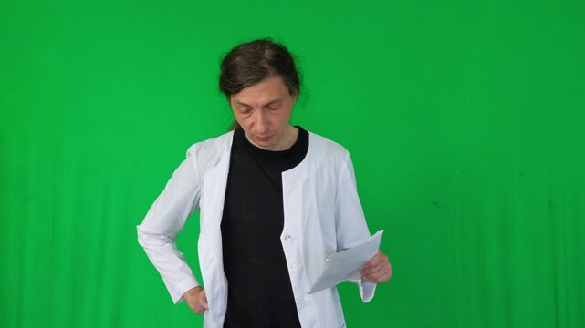 A mid-shot captures a studious and professional mood as a person in a white lab coat meticulously uses a digital tablet, suggesting research, diagnosis, or data entry, green screen background