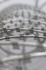 Coils and loops of barbed steel wire