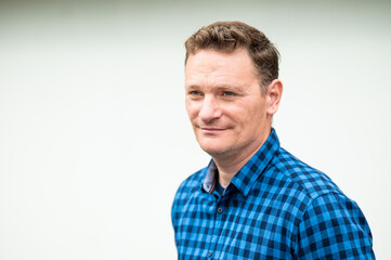 Fototapeta premium Outdoor portrait of a 46 yo white man wearing a checkered blue shirt, Koekelberg, Belgium