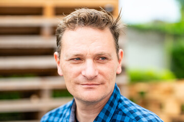 Outdoor portrait of a 46 yo white man wearing a checkered blue shirt, Koekelberg, Belgium