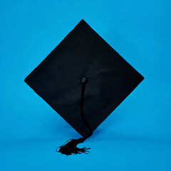 Graduation Cap Rests Symbolically on Blue Background


