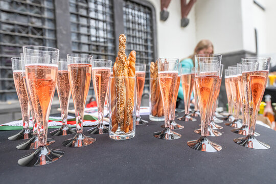 Pouring and tasting of dry sparkling wine champagne festival wedding setup guests