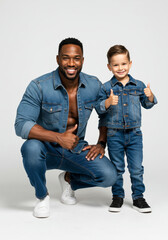 Father and Son Wearing Matching Denim Outfits – Thumbs Up Pose in Studio