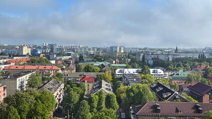 A wide-angle view from a high window overlooking the rooftops of Kaliningrad. The scene captures the mix of modern and historic architecture under a clear or cloudy sky
