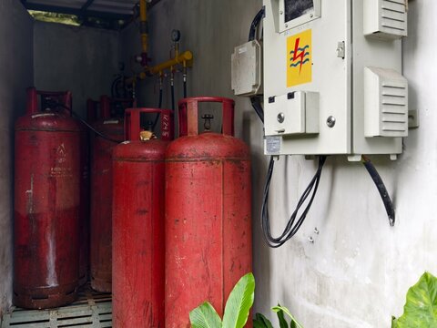 Ubud, Bali, Indonesia – May 12, 2025: Several large red gas cylinders and a control panel areaand pressure gauges for fuel supply