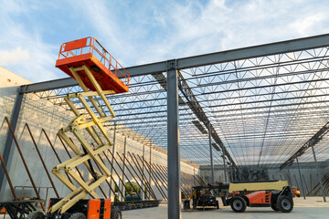 Industrial warehouse construction site. Assembling of metal and concrete frame of new logistics...