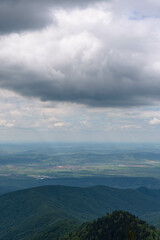 top view from mountain ladder landscape with clouds in summer carpathians romania with lights below clouds and green forests