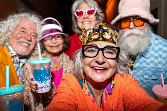 Group of happy senior friends with fancy clothing having party in the night - Powered by Adobe