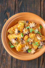 Golden Potato Rosti With Baby Octopuses And Fresh Pea Shoots Garnished Delicately