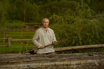 Fototapeta premium man sitting on a log