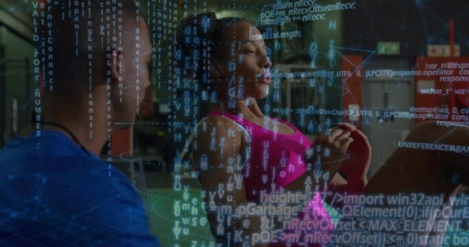 Gym coach adjusting foot initiating data overlay while trainee performing leg presses tracking form