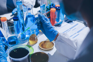 Scientist pipetting medical samples into microplate in laboratory