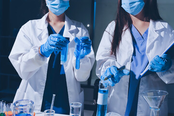 Scientist pipetting medical samples into microplate in laboratory