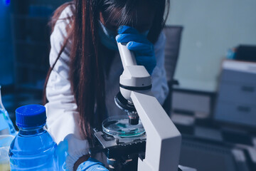Scientist pipetting medical samples into microplate in laboratory