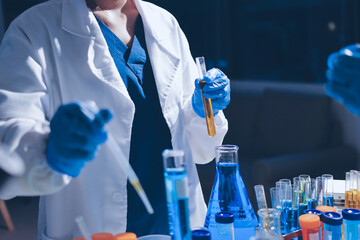 Fototapeta premium Scientist pipetting medical samples into microplate in laboratory