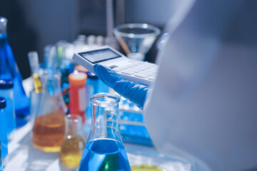 Scientist pipetting medical samples into microplate in laboratory