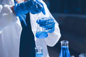Scientist pipetting medical samples into microplate in laboratory