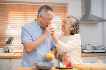 Couple enjoying playful moment in kitchen while preparing food together